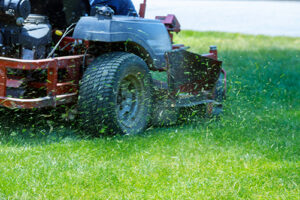 Using landscaping supplies to mow a lawn