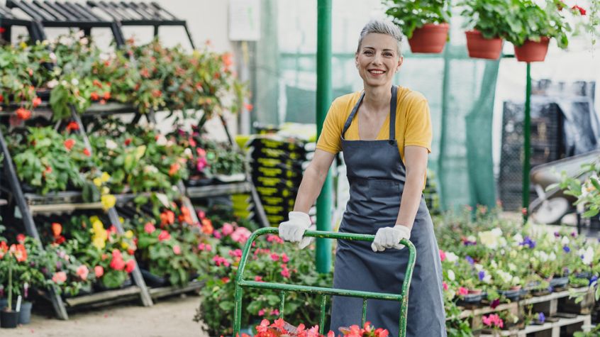 Woman pushing cart in New Jersey garden store